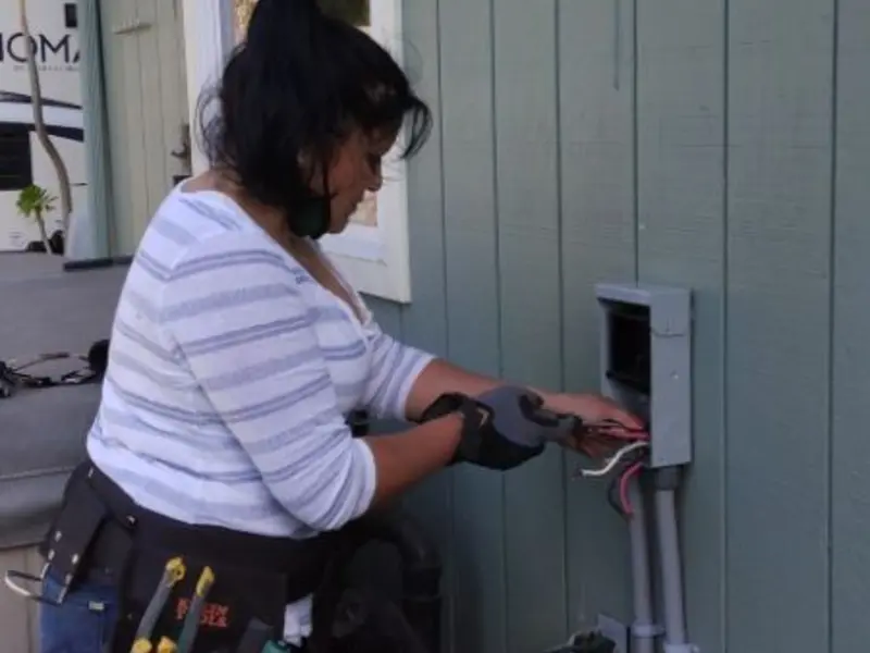 Licensed electrician wiring an exterior subpanel in Belmont